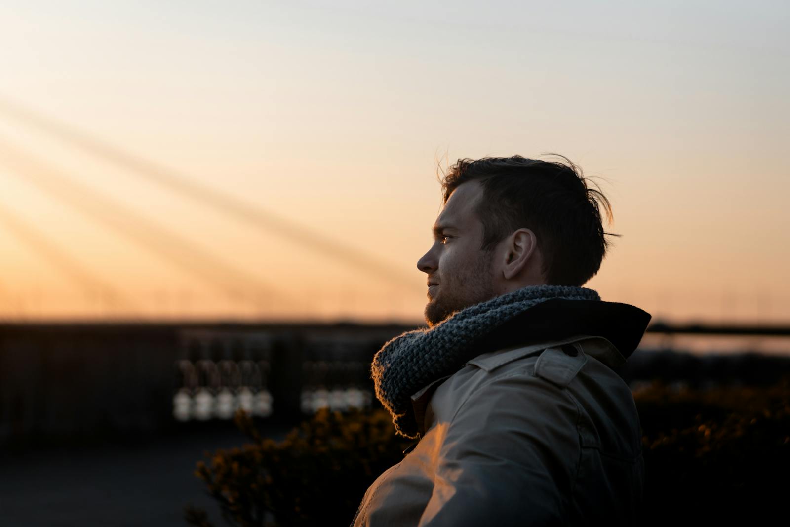 A man enjoys a tranquil moment at sunset outdoors, embodying leisure and tranquility.