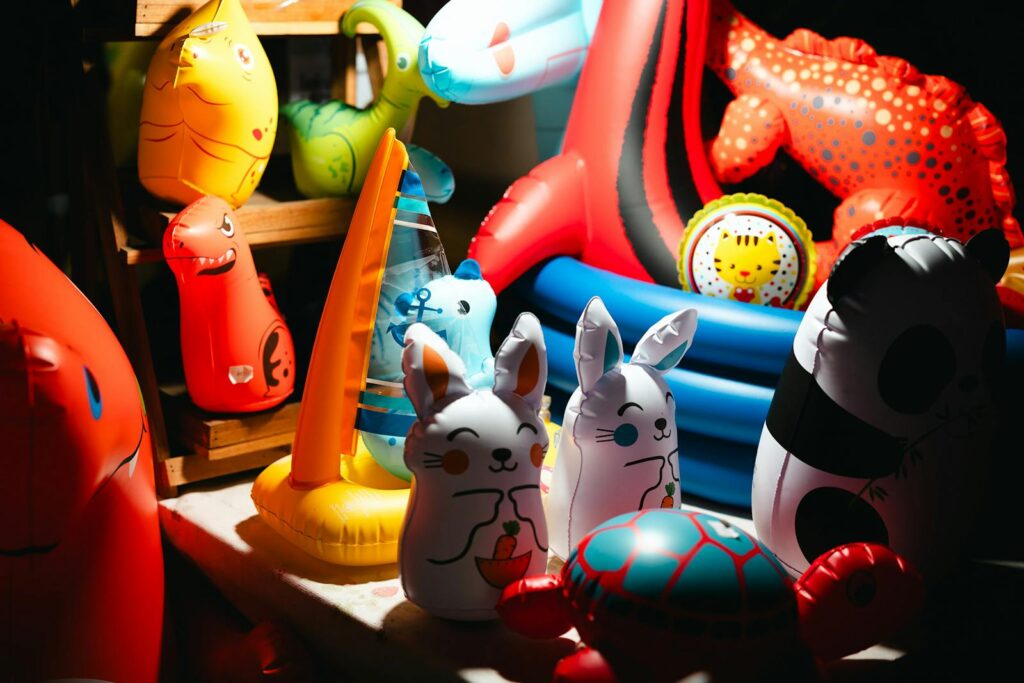 Bright and colorful inflatable toys in a playful kids' room setting.