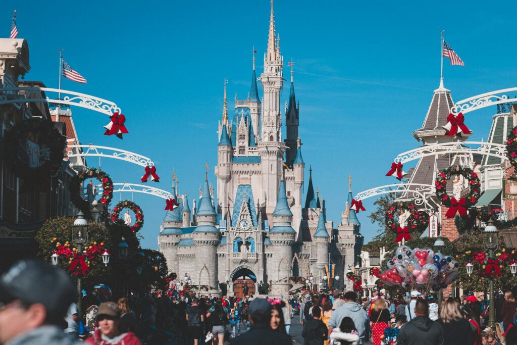 A busy day at Orlando's Magic Kingdom with crowds enjoying holiday decorations.