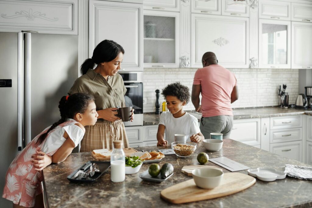 A family preparing breakfast together in a cozy kitchen setting, showcasing togetherness and morning routine.