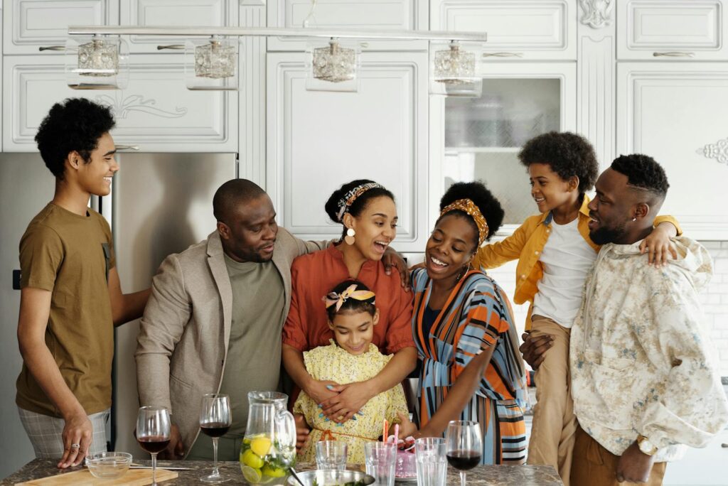 A happy family enjoying a gathering in a contemporary kitchen, sharing smiles and warmth.