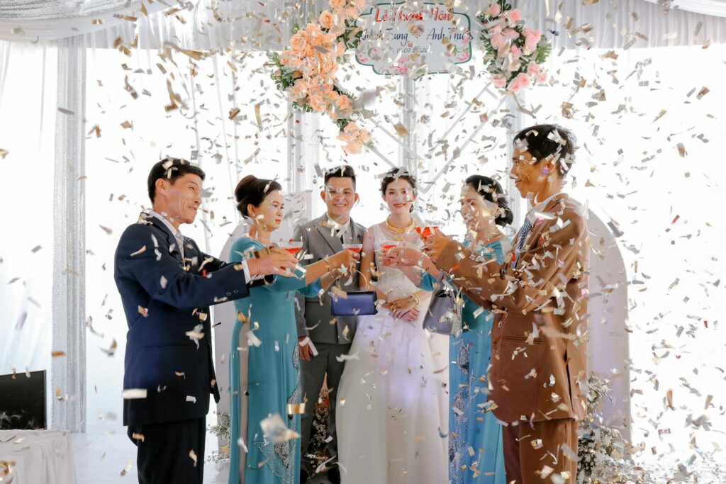 Asian wedding ceremony with confetti, showcasing an elegant and joyful celebration among family.