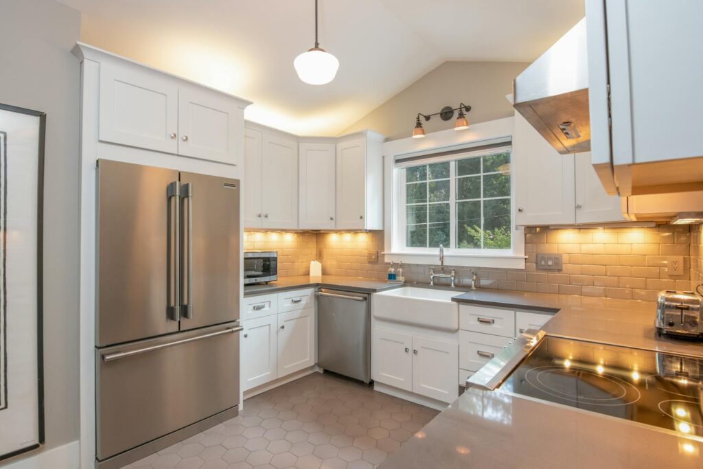 Bright and sleek modern kitchen featuring stainless steel appliances and white cabinetry.