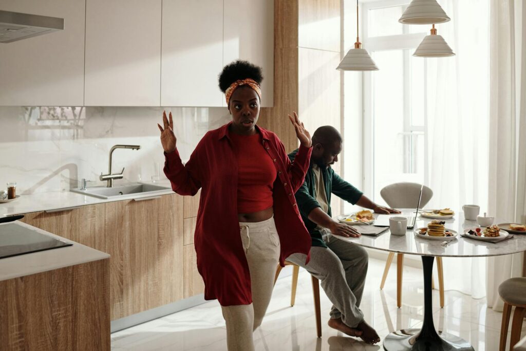 A couple in a kitchen having a morning breakfast with visible emotions.