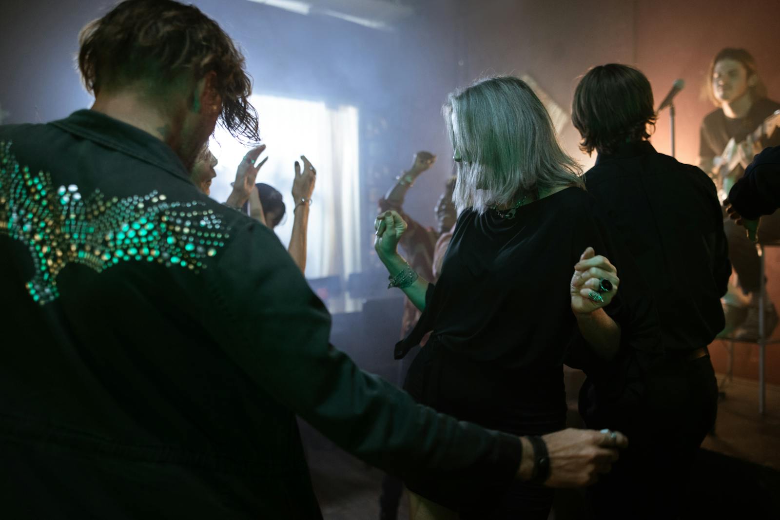 Energetic dance scene at a nightclub with live music and lively crowd.