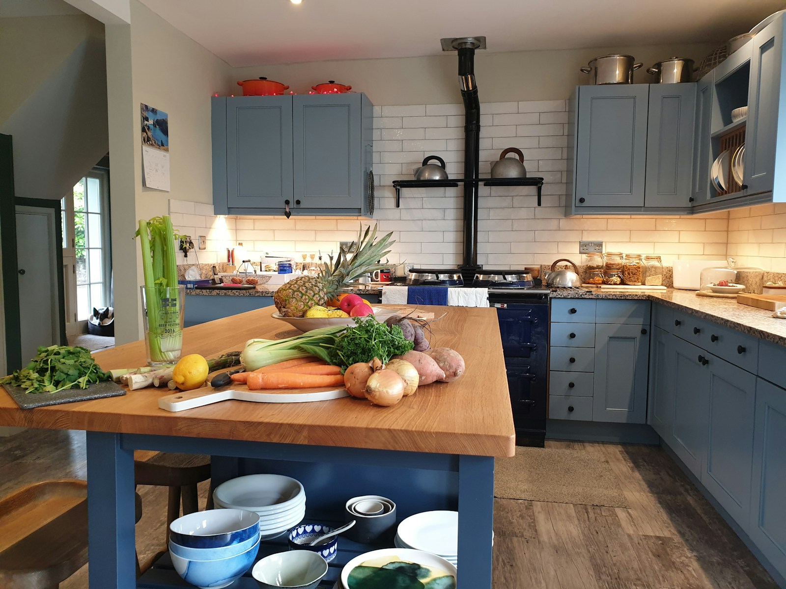 a kitchen with a table full of vegetables
