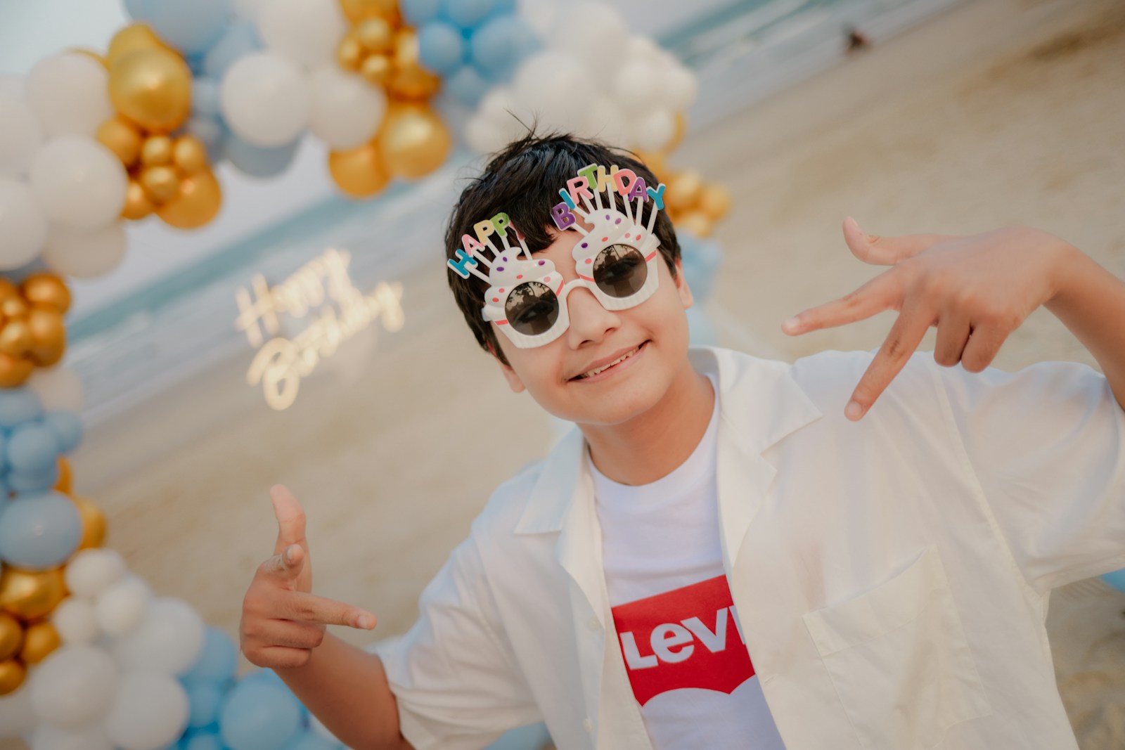 Young person celebrating birthday on a beach