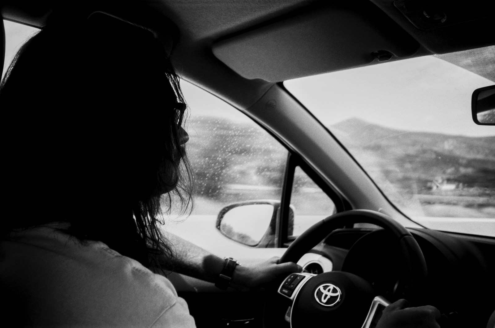 a woman driving a car in the rain