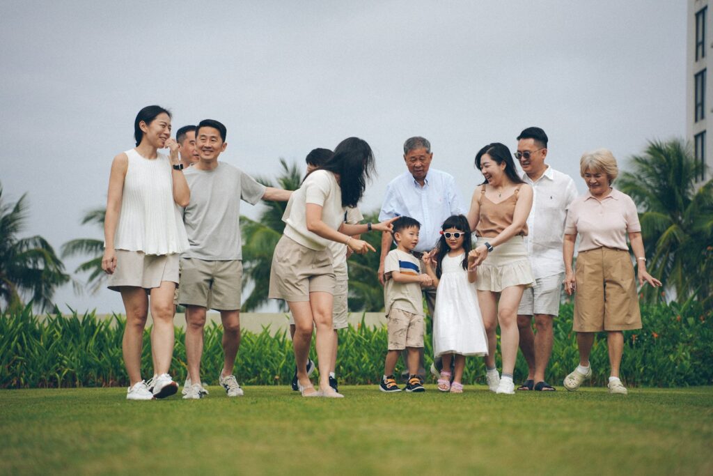 A multigenerational family poses for a photo outdoors.