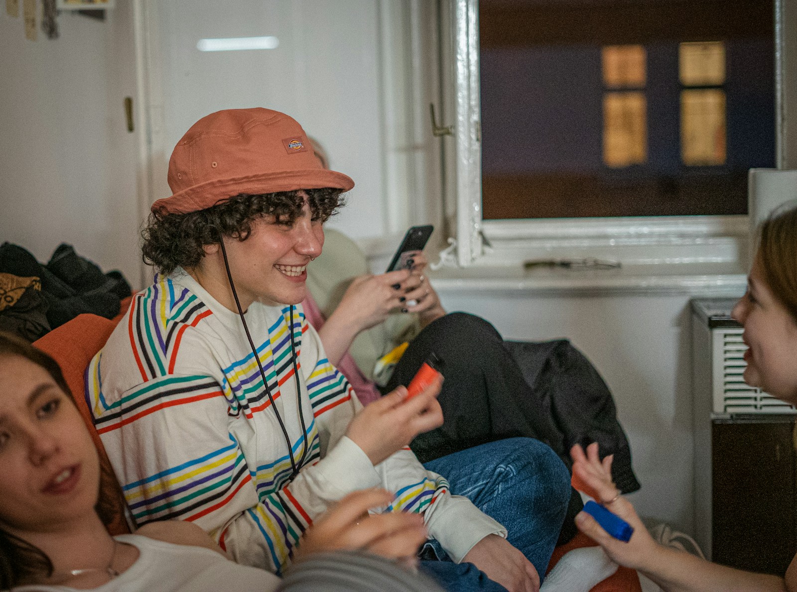a group of people sitting on a couch with cell phones