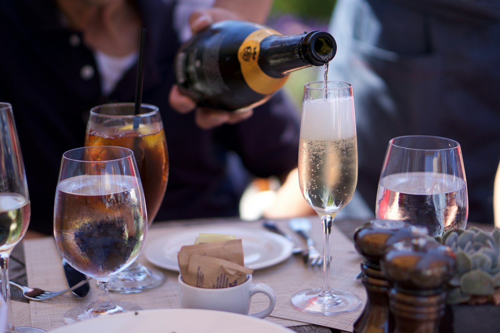Pouring champagne into a flute at a formal dinner