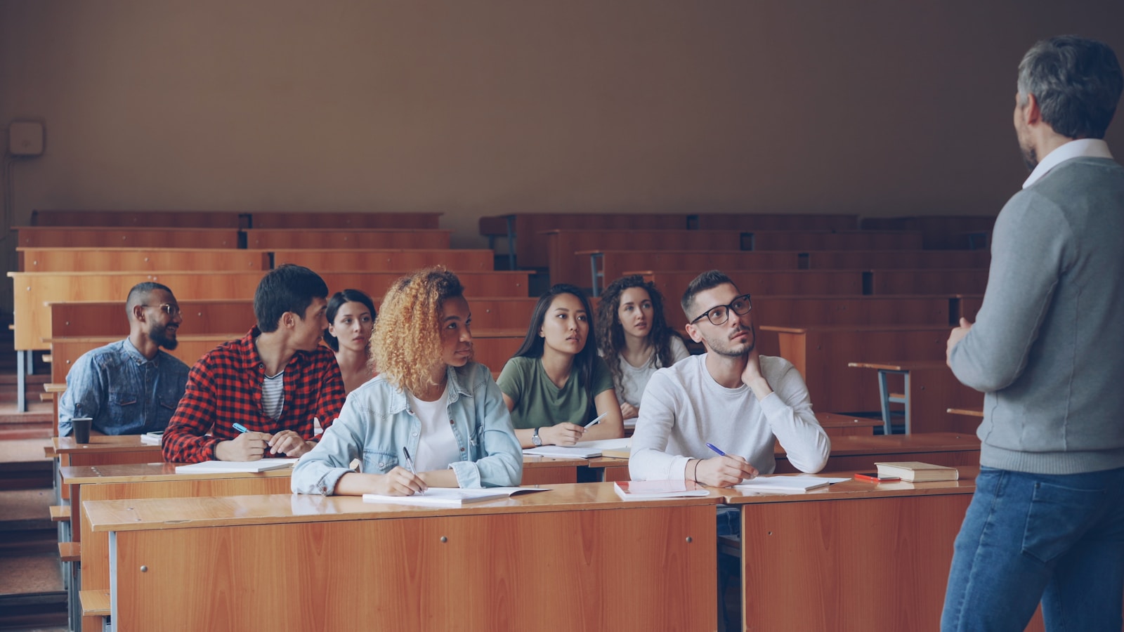 Professor teaching students in a lecture hall