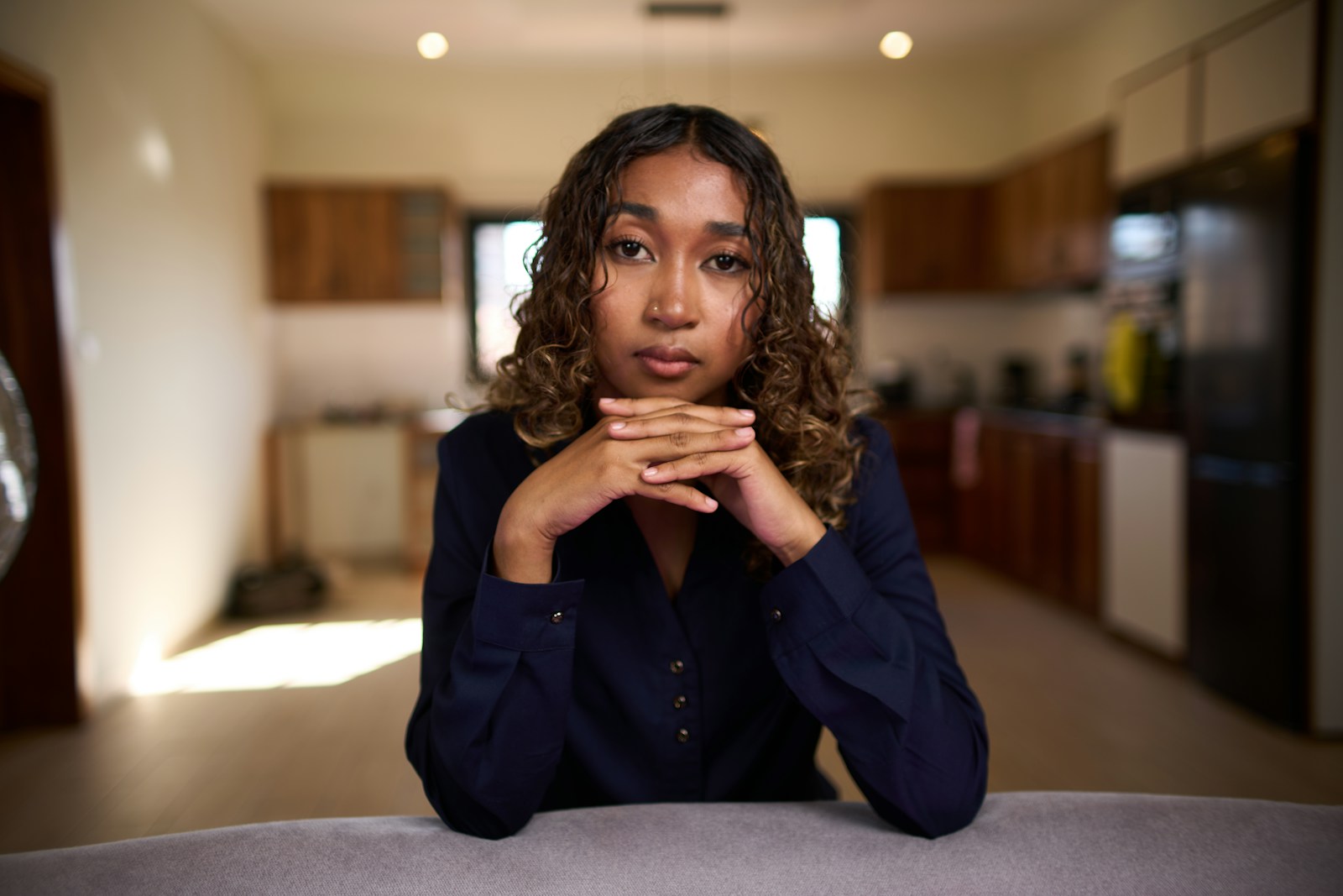 Young woman with curly hair looking at camera