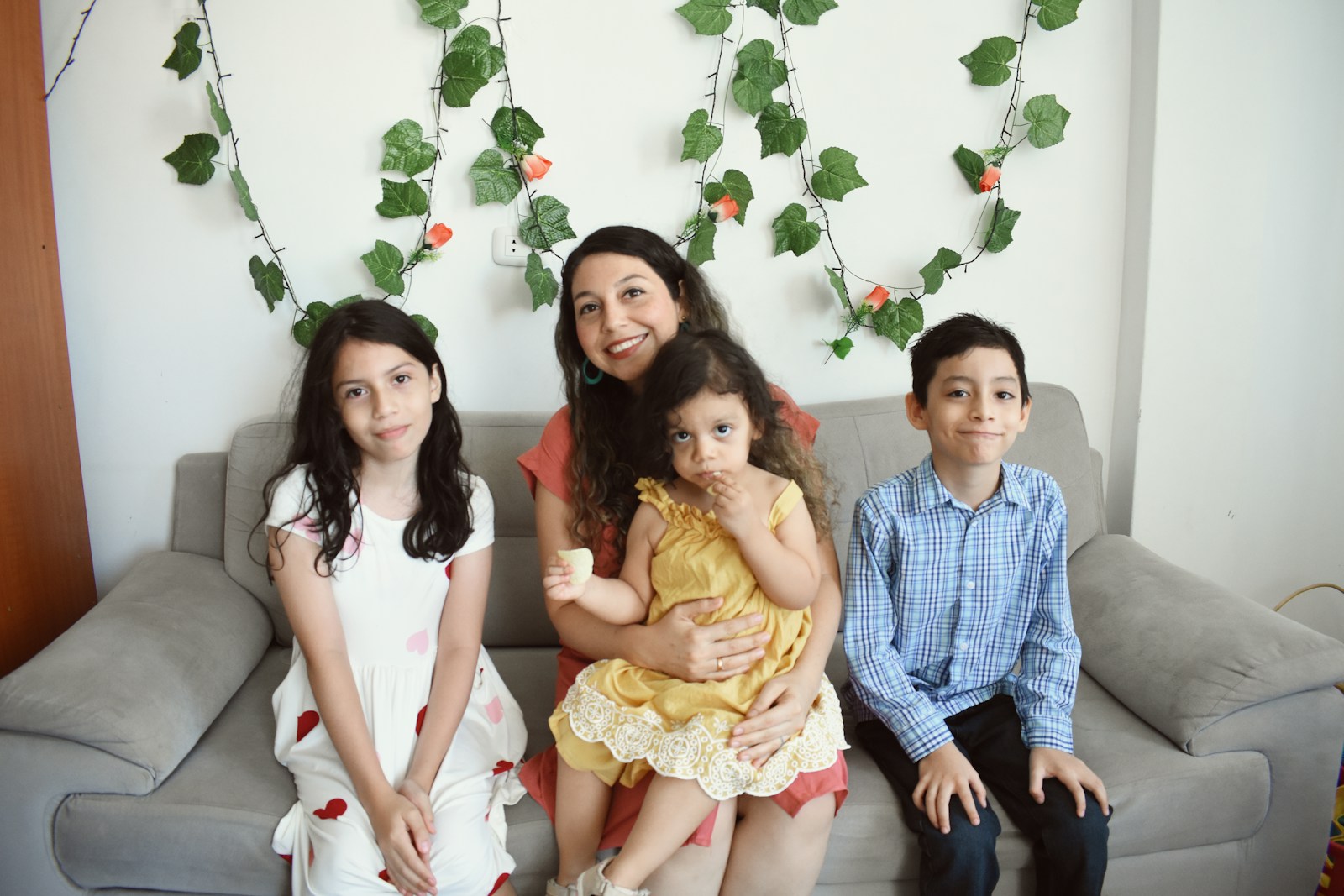 a group of people sitting on a couch posing for the camera