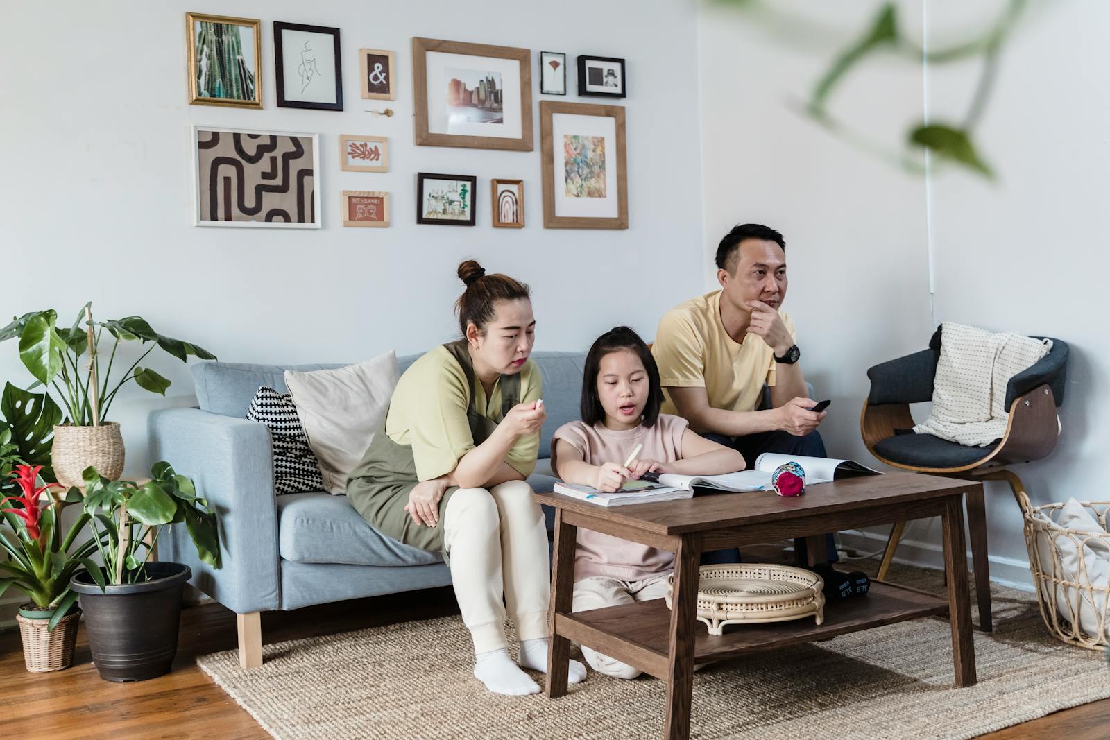 An Asian family enjoys a casual time together in a beautifully decorated living room.