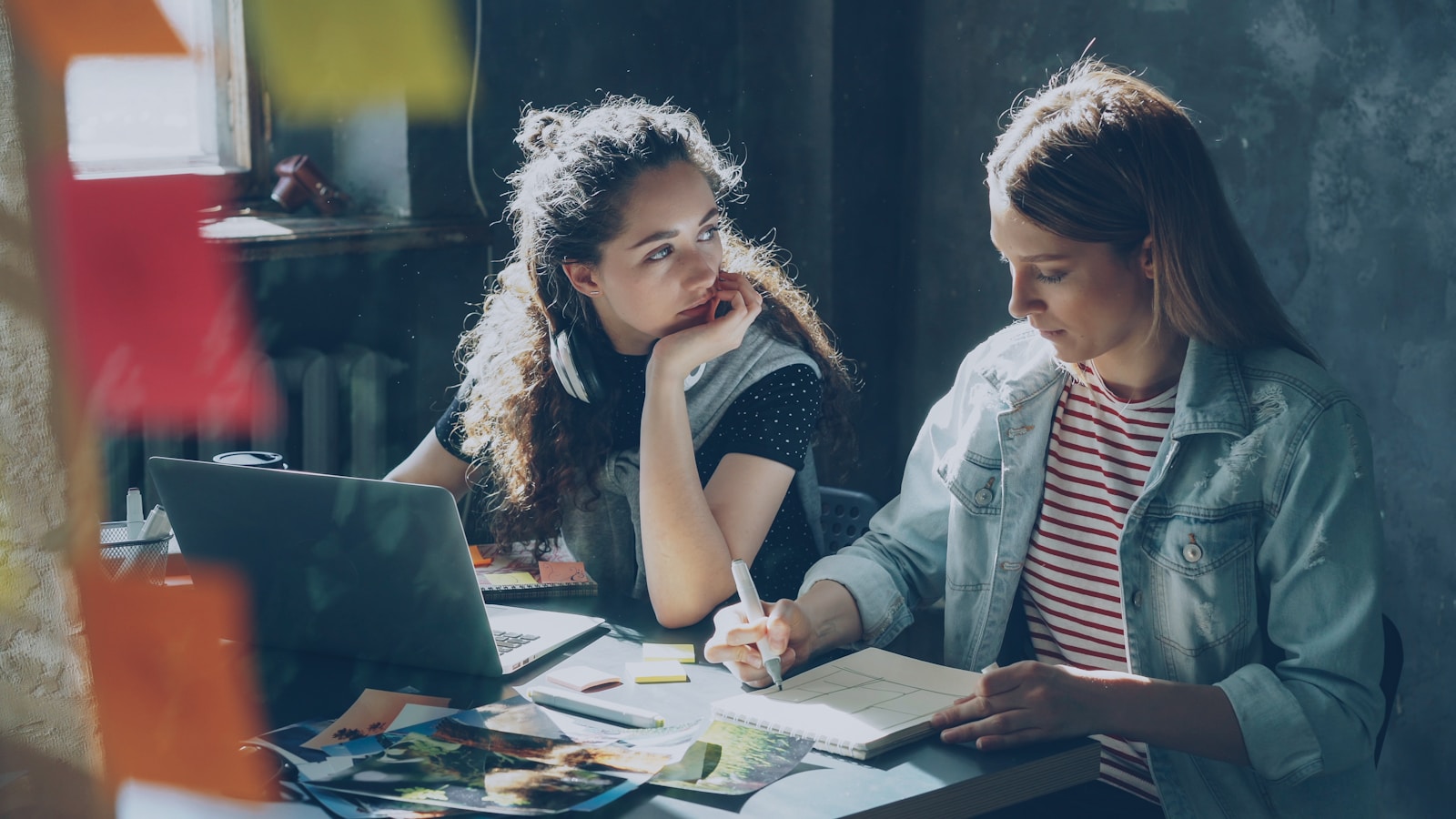 Two women are working together on a project.