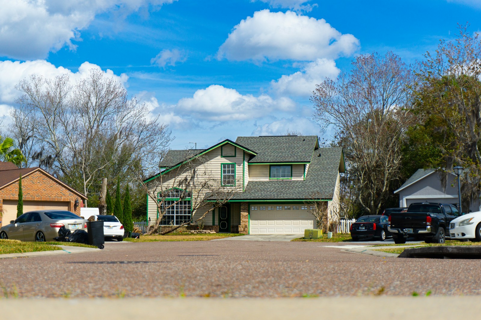 Suburban street with houses and parked cars
