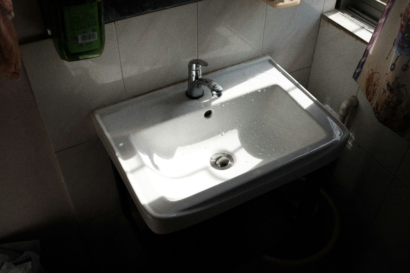 a white sink in a bathroom next to a window