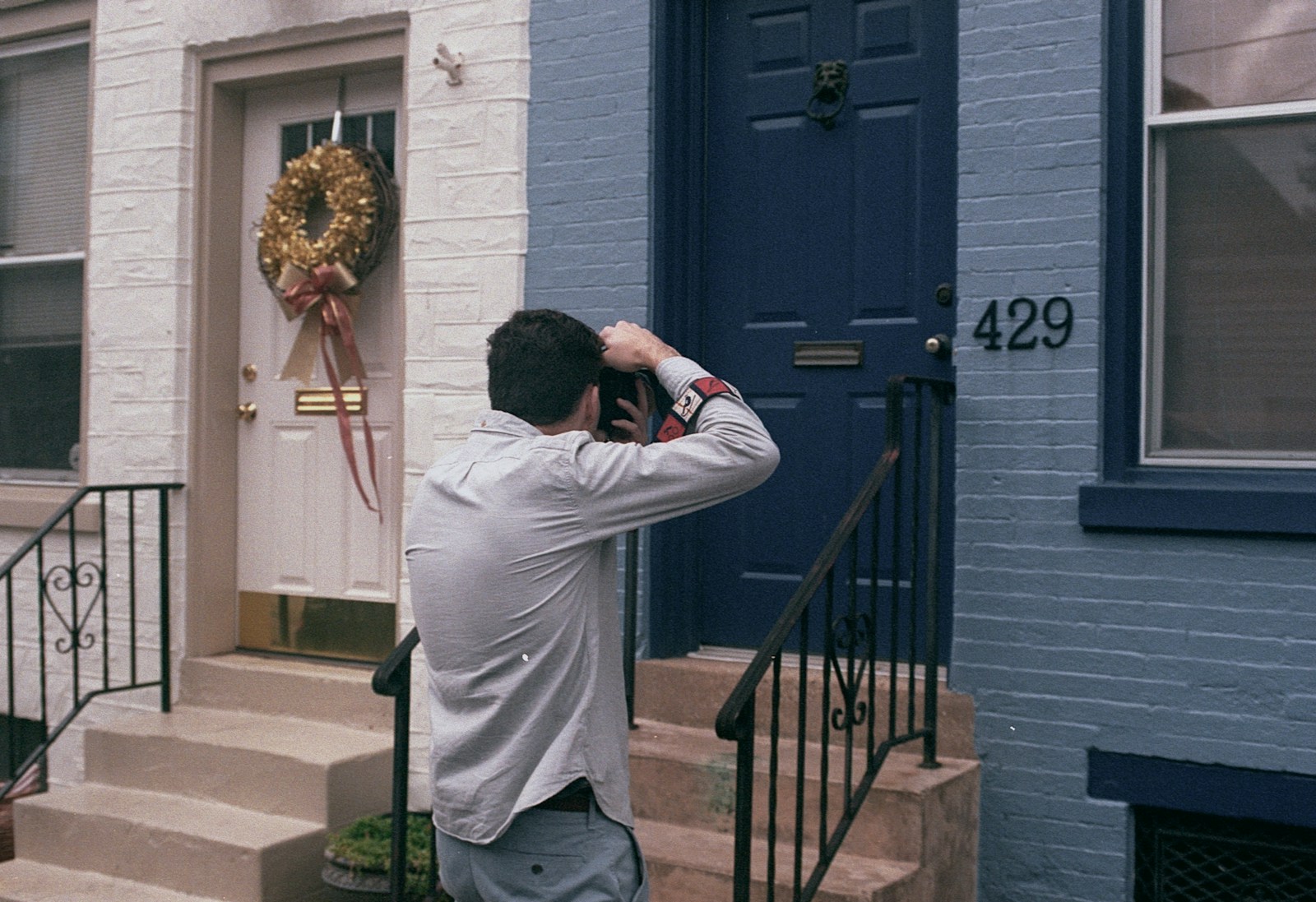a man standing in front of a blue door