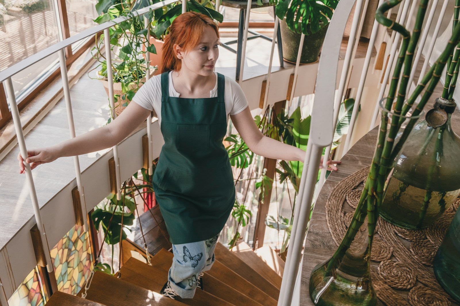 A woman with red hair is walking up a set of stairs