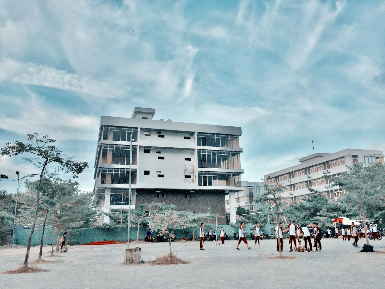 people walking on street near white concrete building during daytime