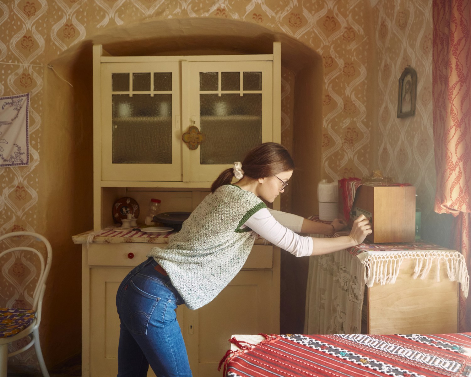 A woman standing in a room next to a table