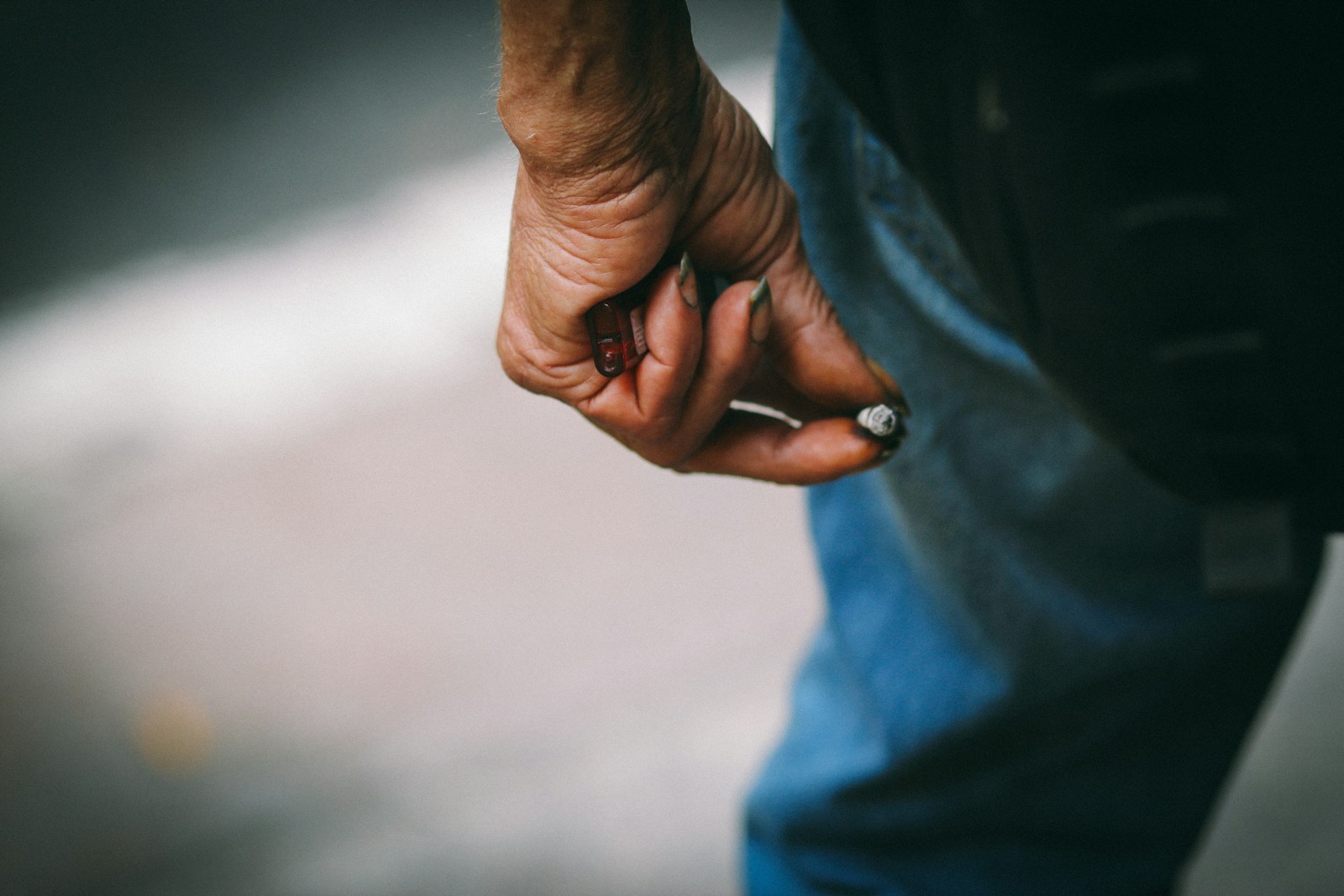 person in blue denim jeans wearing silver ring