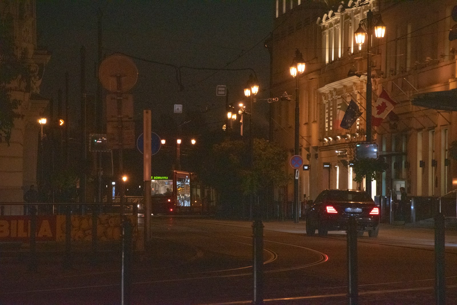a street with cars on it and buildings on the side