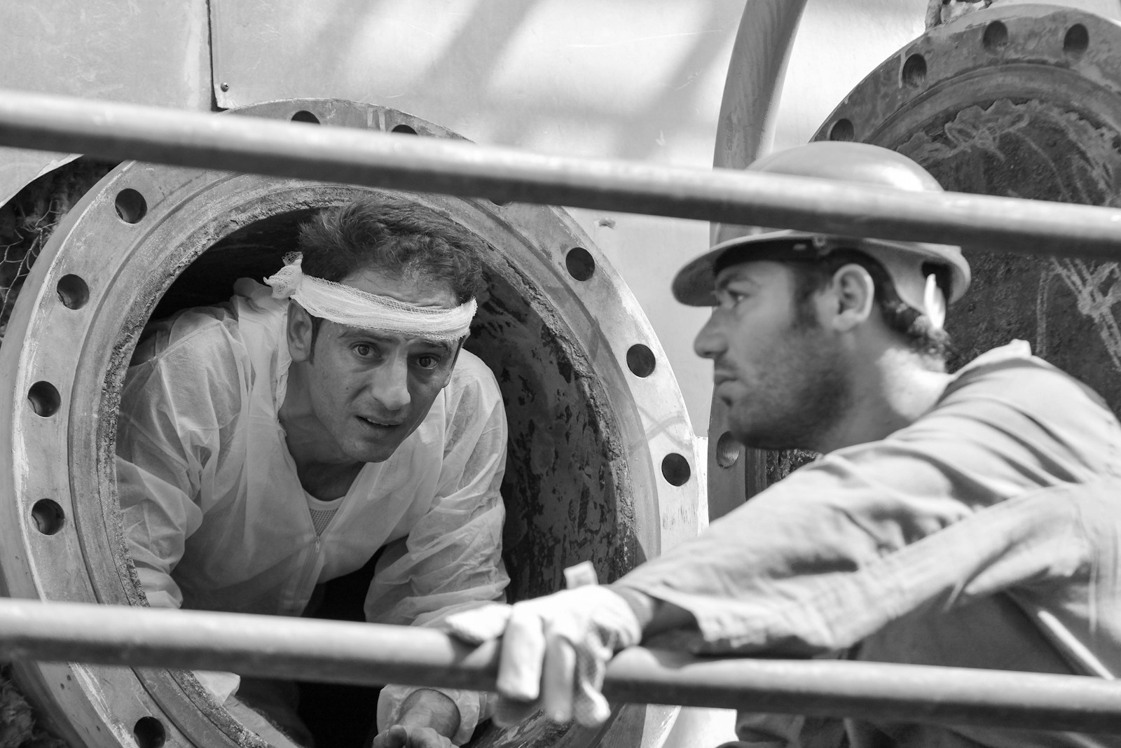 a man in a hat looking at a man in a military uniform