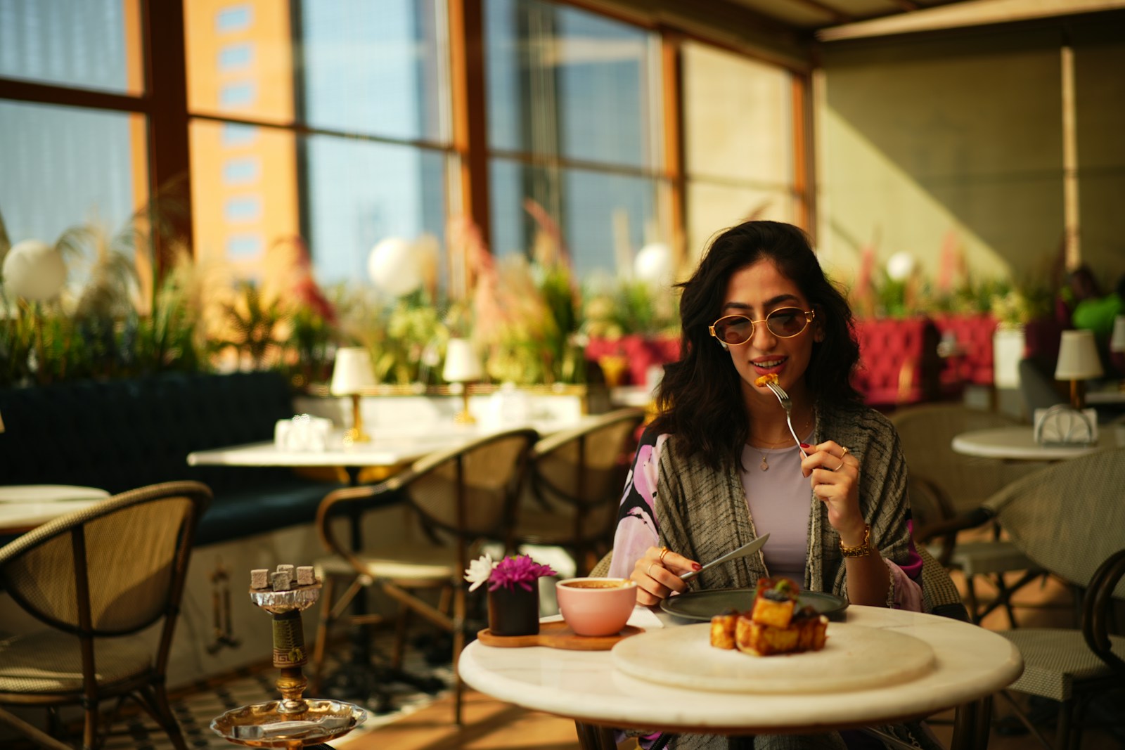 Woman eats dessert at a fancy restaurant.
