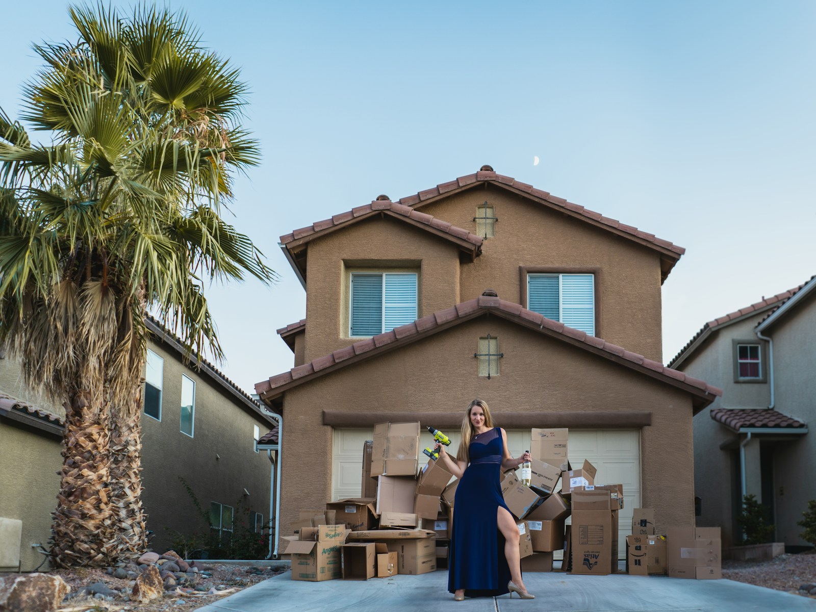 woman in black long sleeve shirt and black pants standing near brown concrete building during daytime