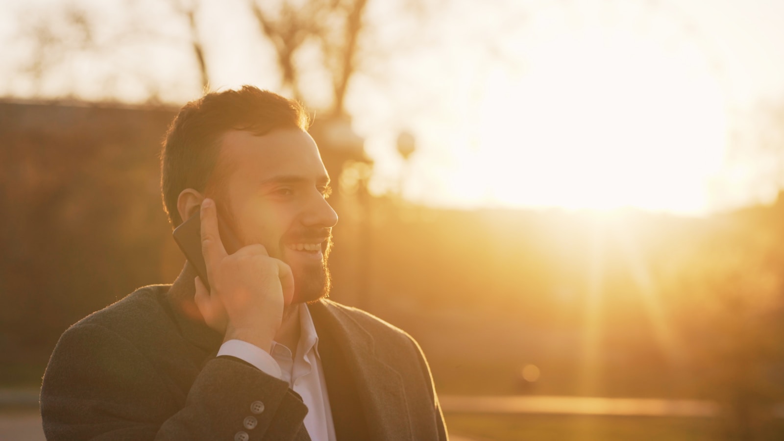 Man talking on phone during sunset