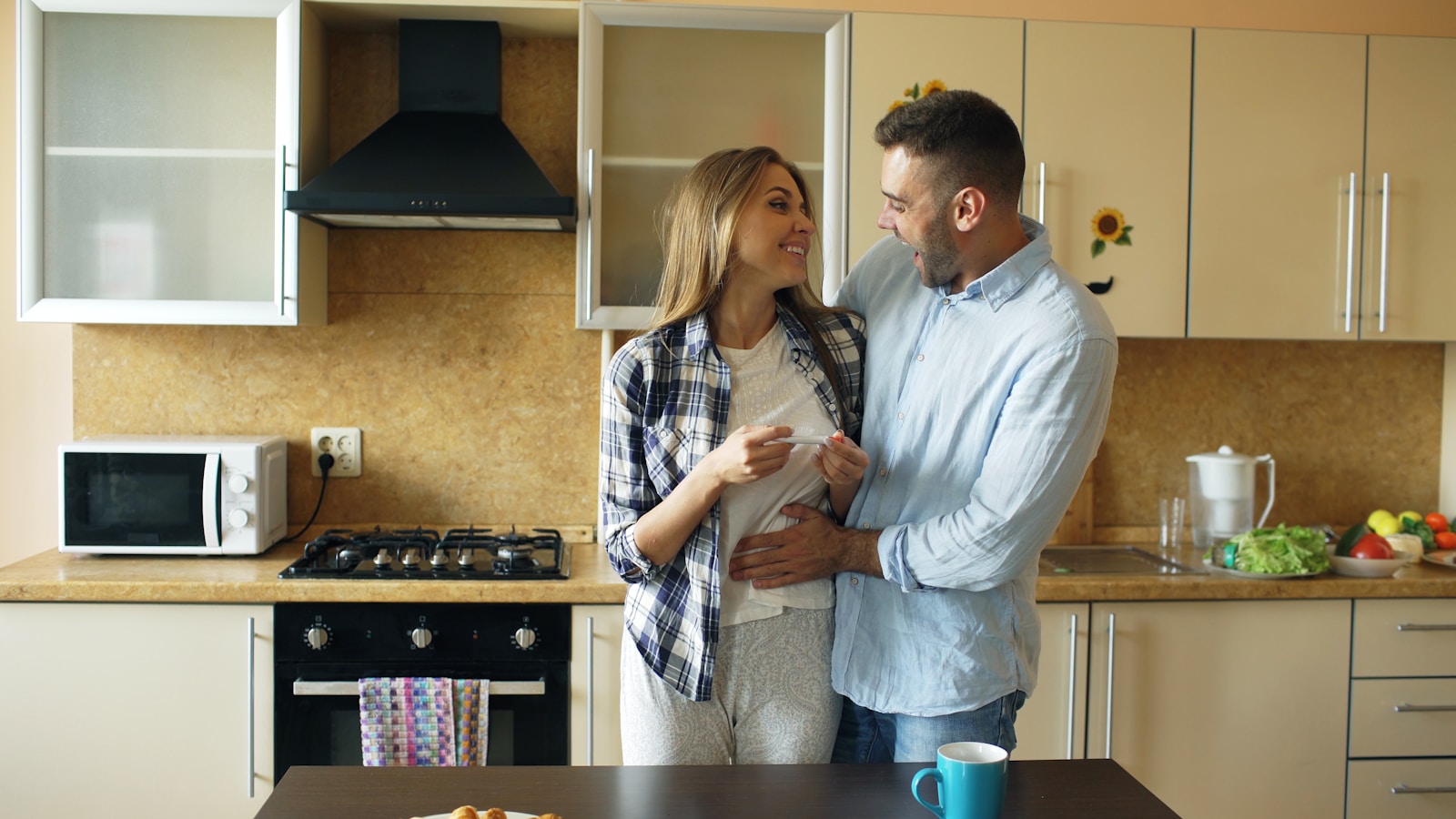 Couple embracing in a modern kitchen