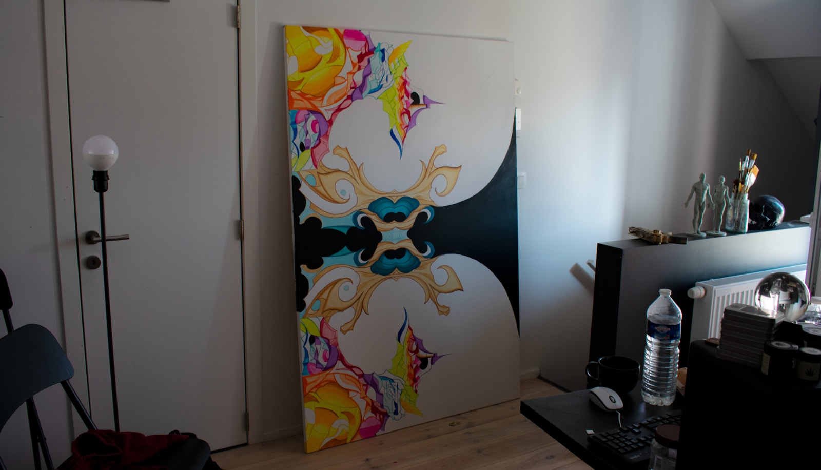 A colorful painting stands in a room.
