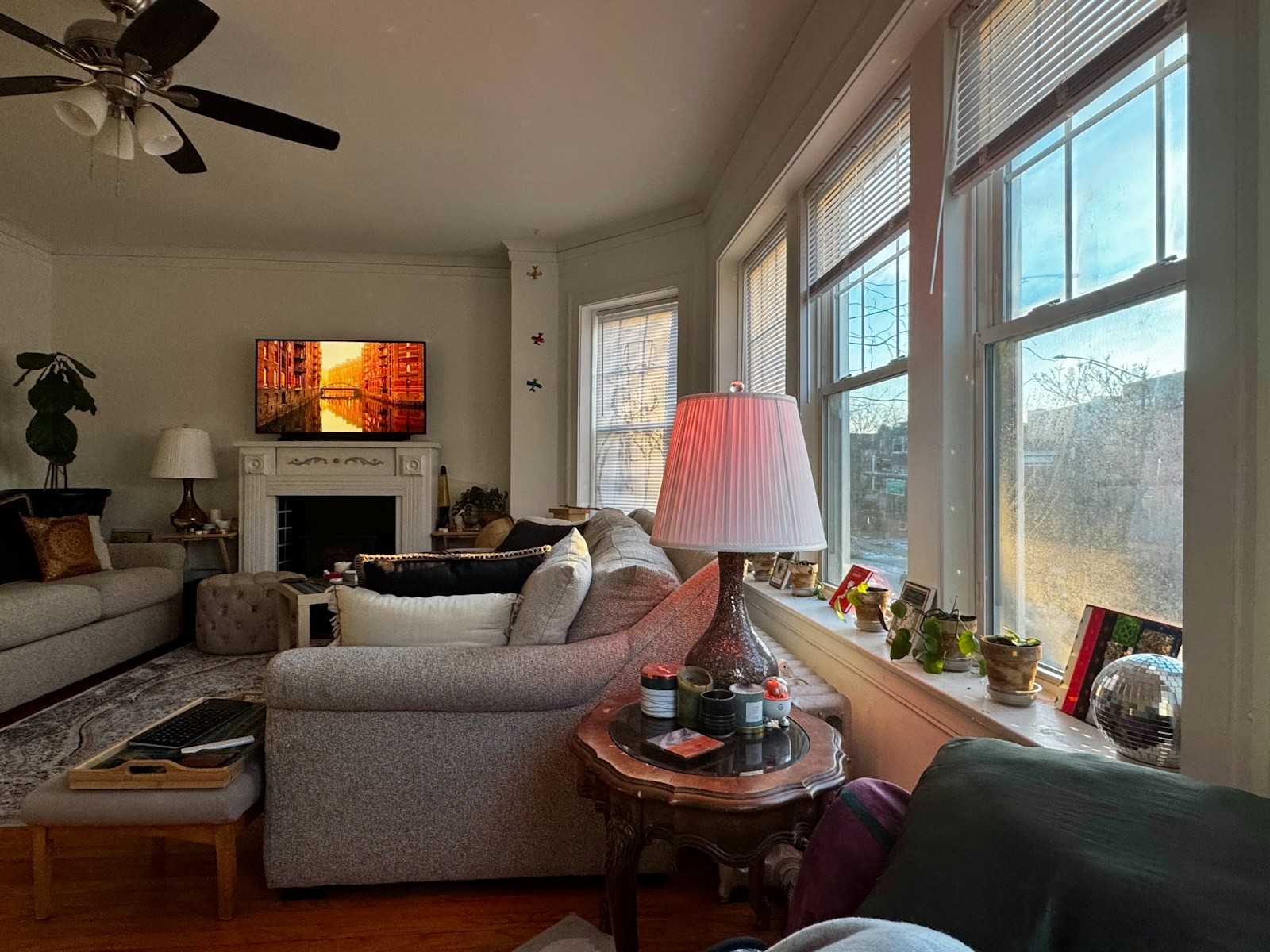 Cozy living room with fireplace and large windows.