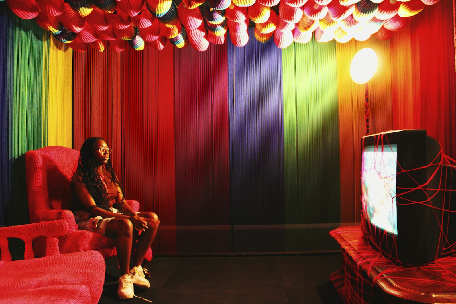 A person sitting in a chair in front of a TV