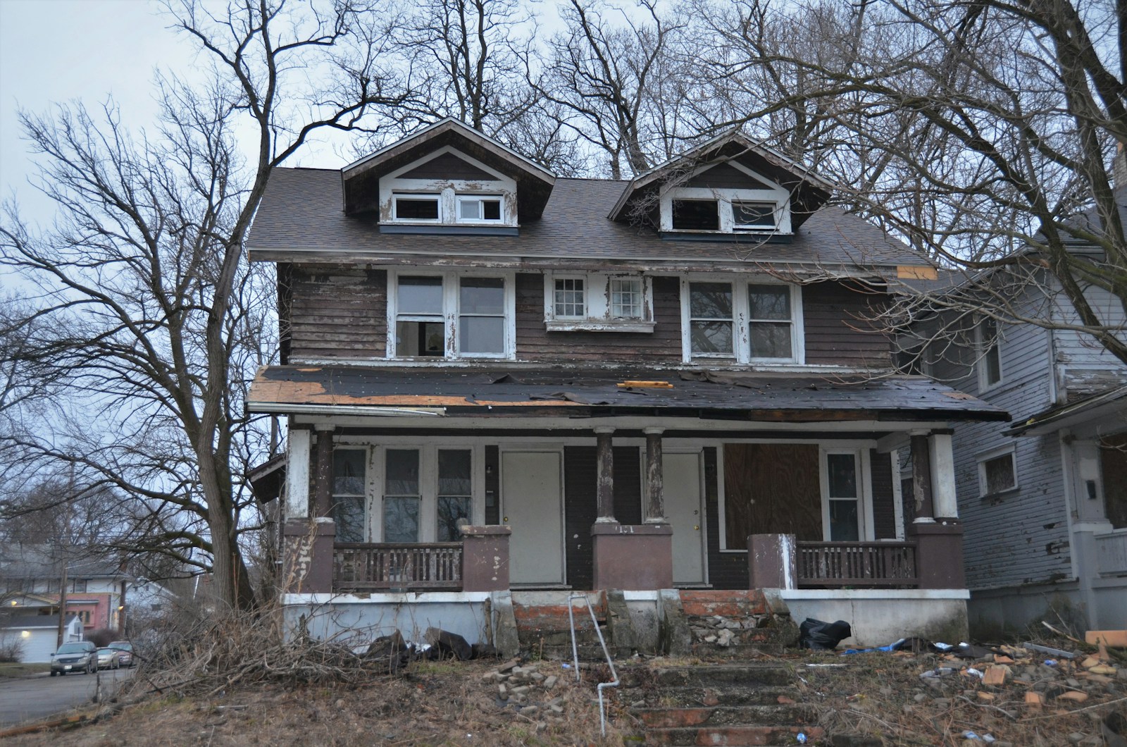 a run down house with a lot of windows