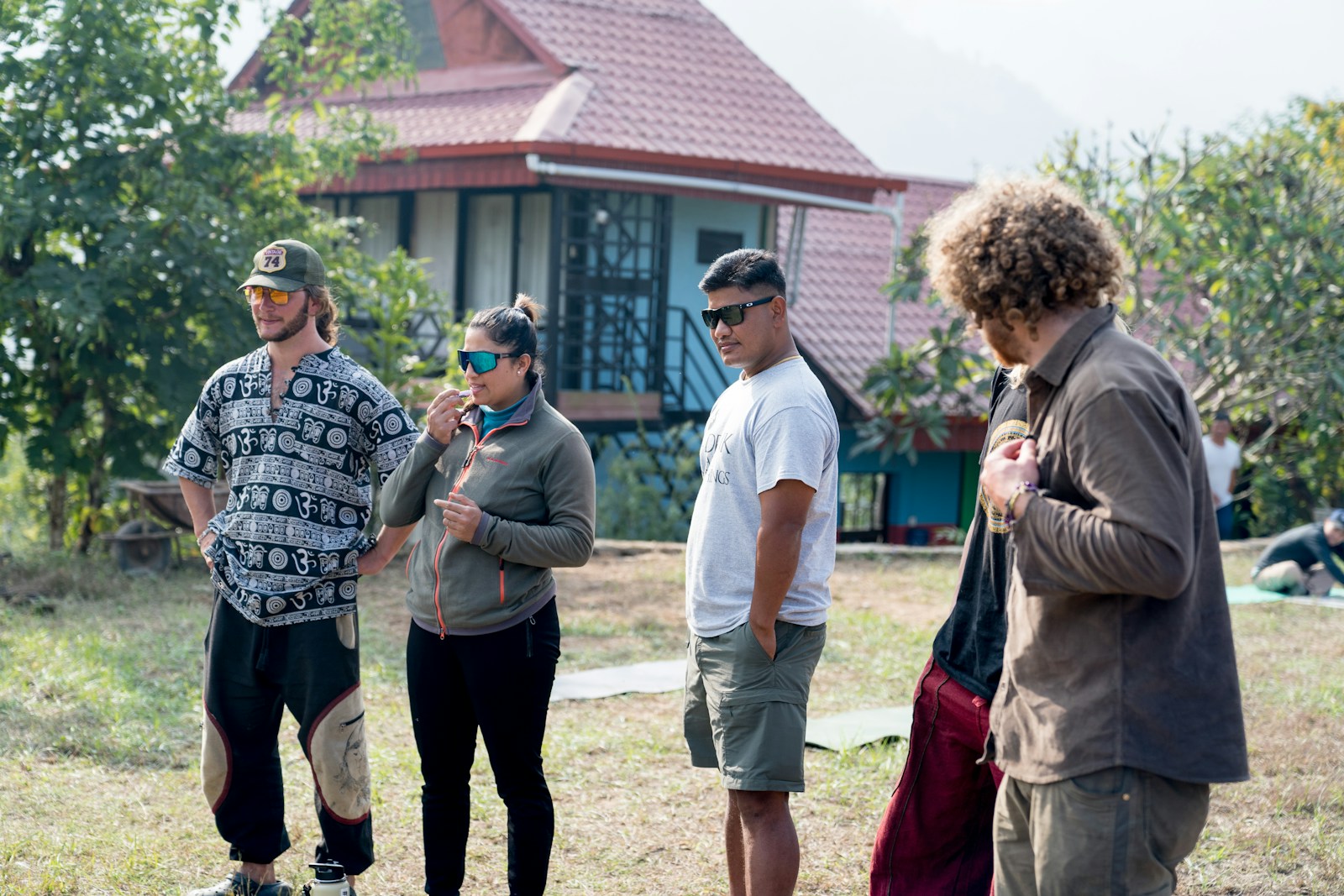 A group of people standing in front of a house