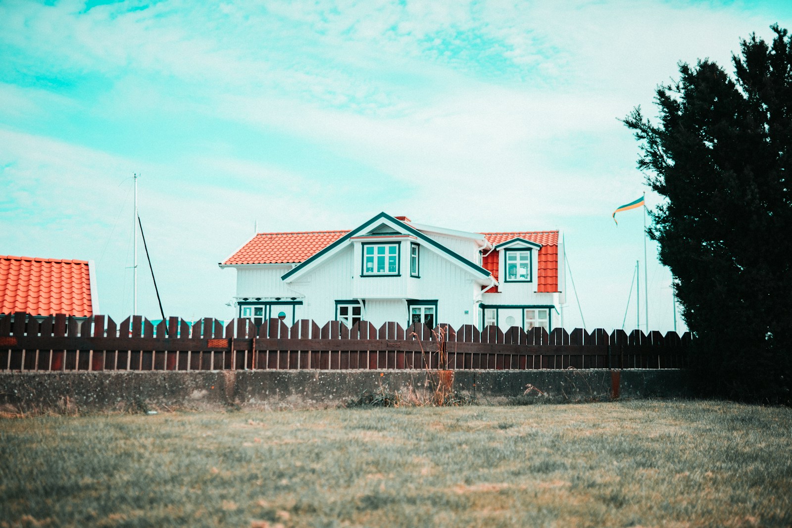 white and orange house under white clouds