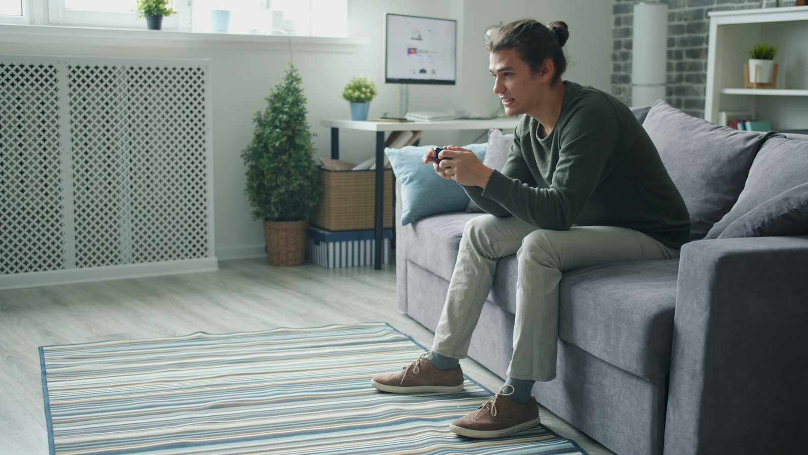 Man playing video games on couch