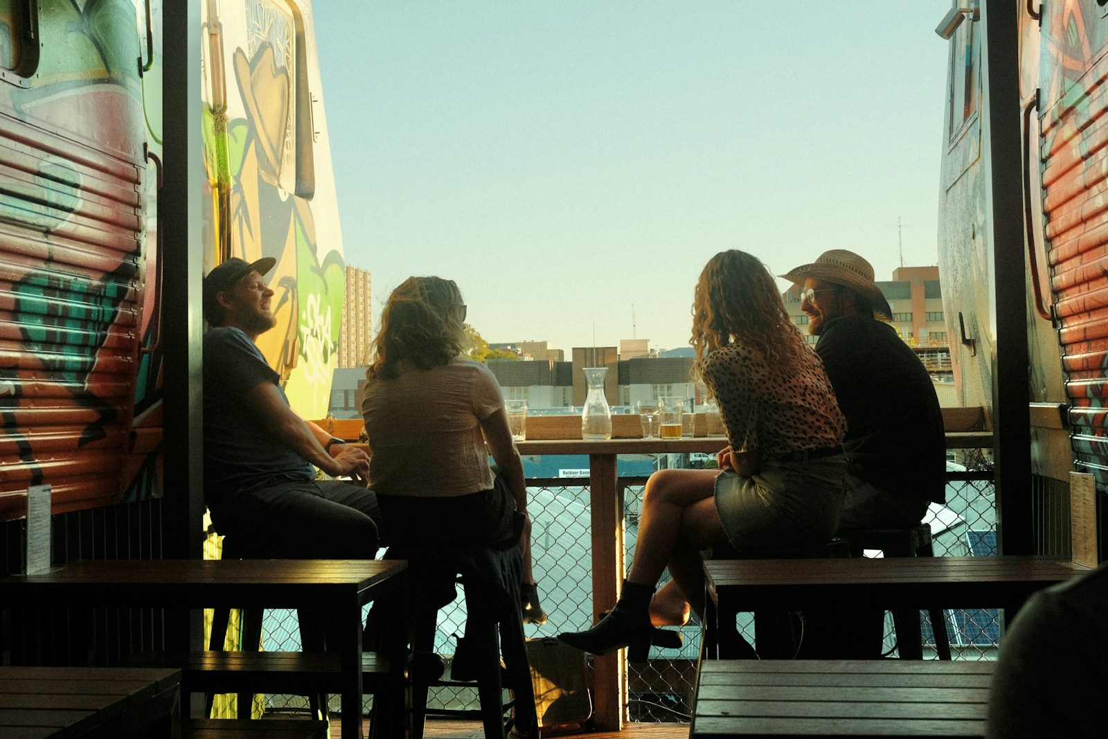 a group of people sitting on top of a wooden bench