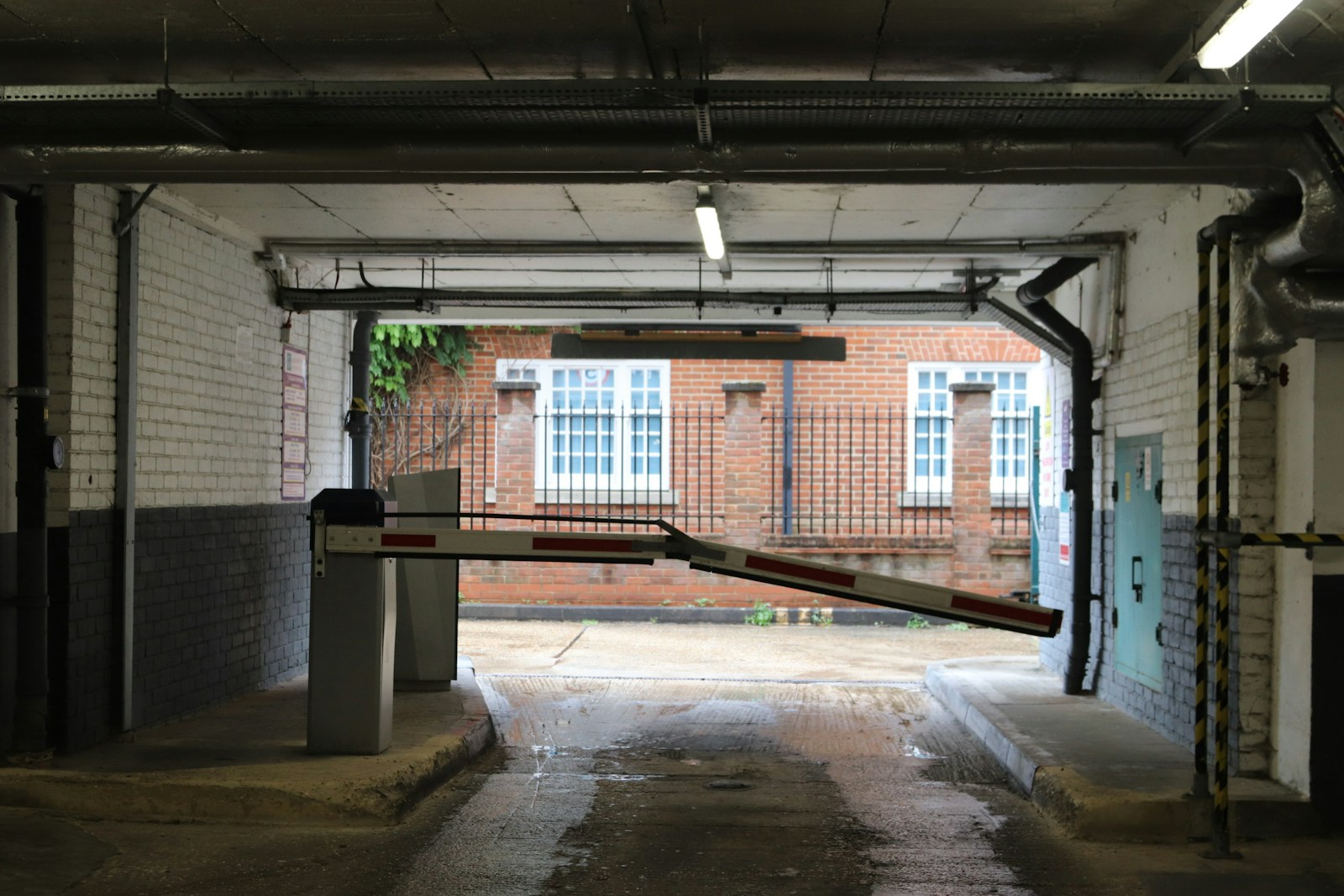 A parking garage entrance with a barrier is visible.