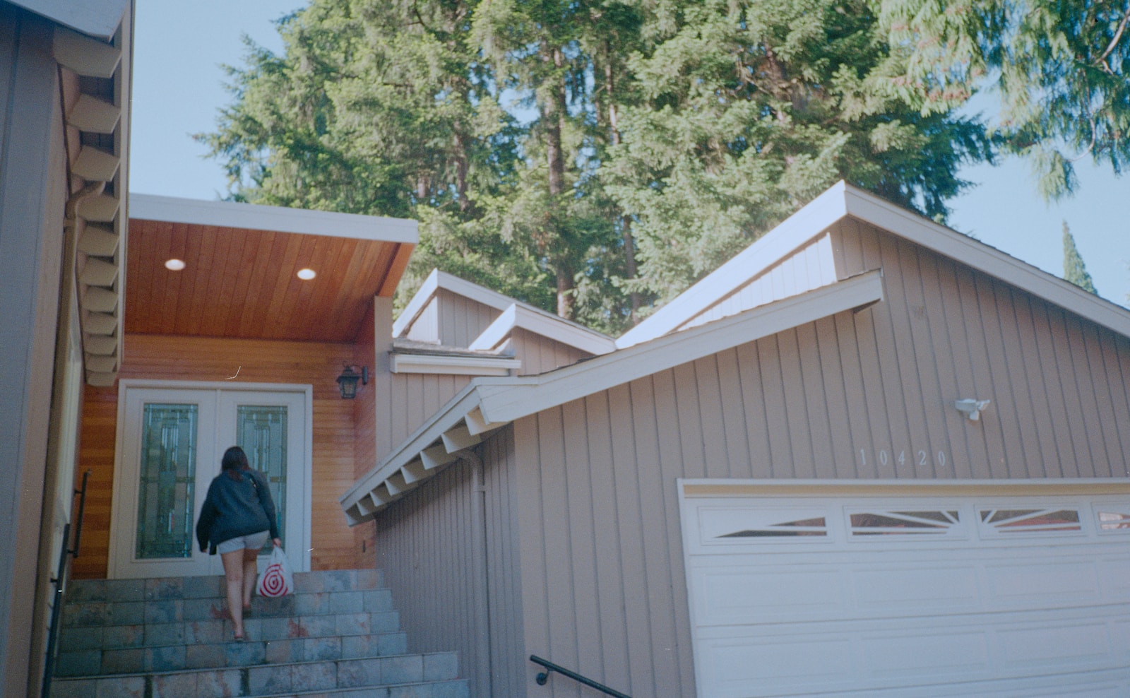 a person standing on the steps of a house