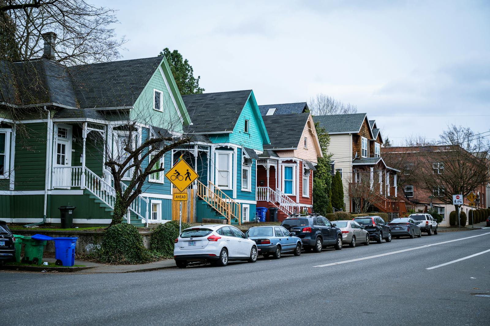 Picturesque street view of colorful, charming houses in a Portland, OR suburb, showcasing urban living.