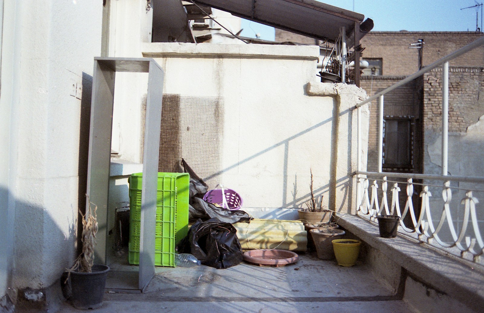 A rooftop balcony with miscellaneous objects.
