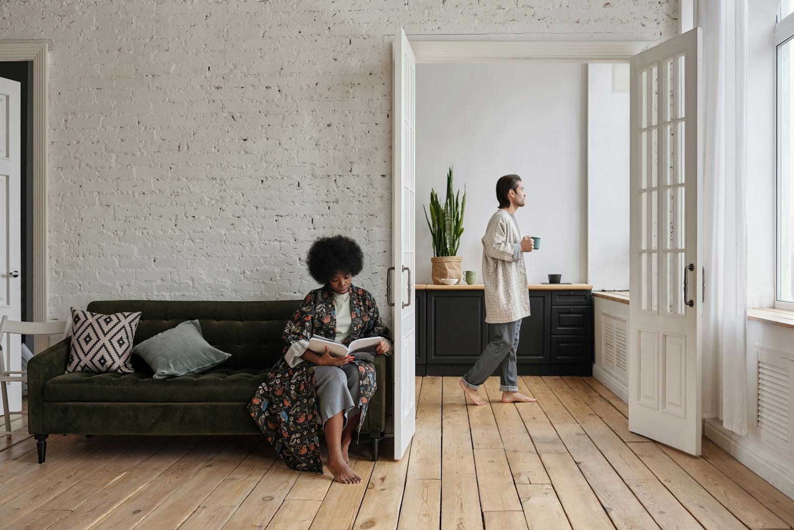 A serene scene of a couple enjoying leisure time in a stylish living room.