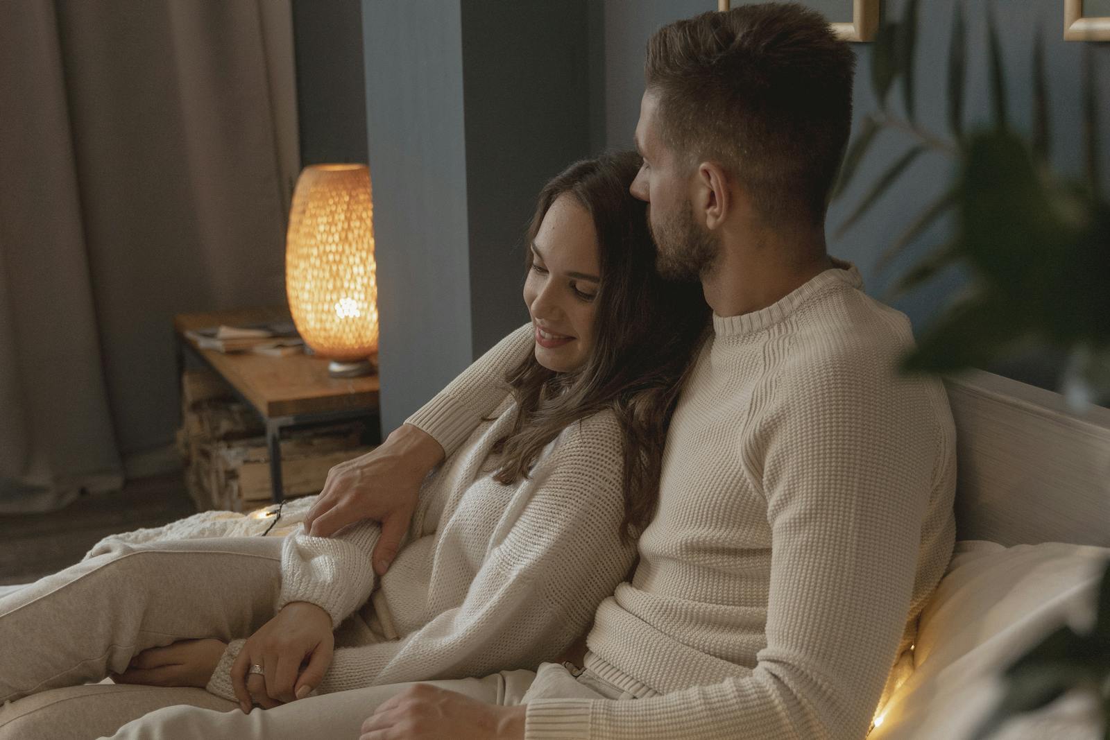 A serene couple embraces in their cozy bedroom, exemplifying love and togetherness.