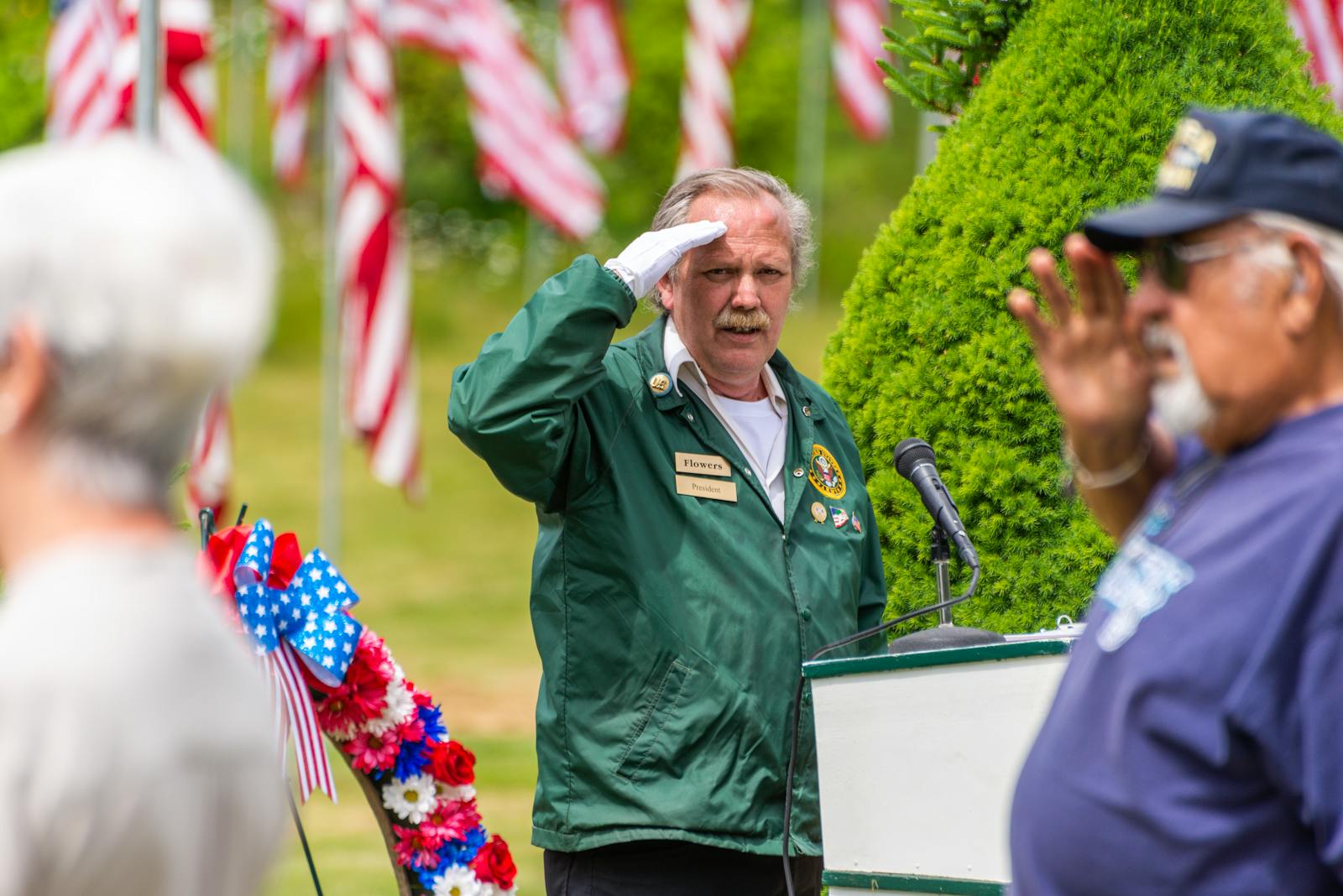 A heartfelt ceremony honoring veterans with salutes and American flags.
