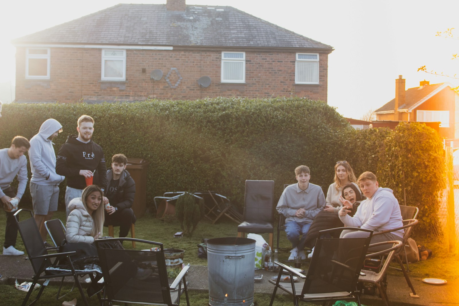people sitting on chairs near brown brick building during daytime