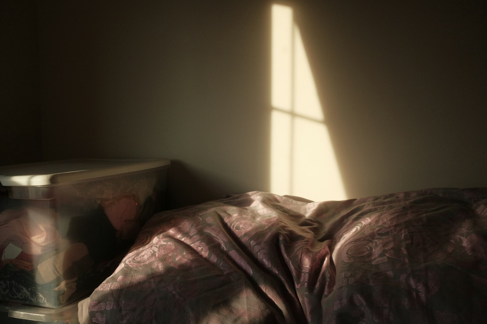 Person sleeping in a dimly lit room.